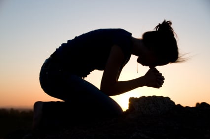 woman kneeling praying